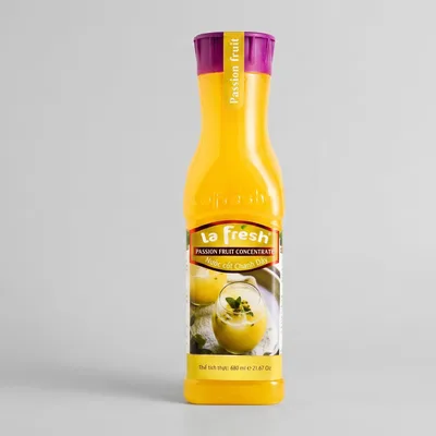 Tall yellow La Fresh bottle with a purple cap, labelled passion fruit concentrate, showing a photo of a creamy passionfruit drink.