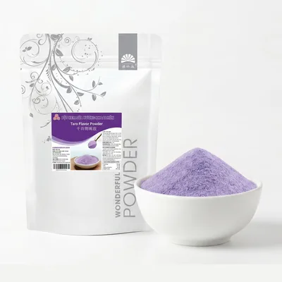 White Wonderful stand-up pouch of taro flavour powder with a purple label, beside a white bowl heaped with pale purple powder.
